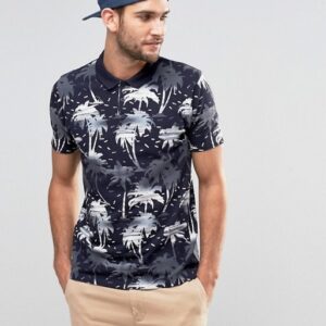 A man wearing a Polo Shirt in Navy with a palm print.
