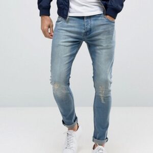 A man wearing Brave Soul Skinny ripped jeans and a blue bomber jacket.