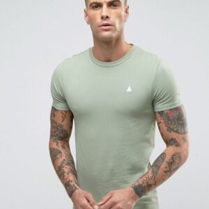 A man wearing a sage green t - shirt with tattoos.