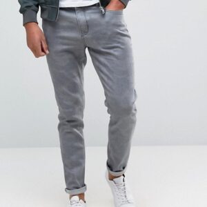 A man wearing Grey Camo Skinny jeans and a black jacket.