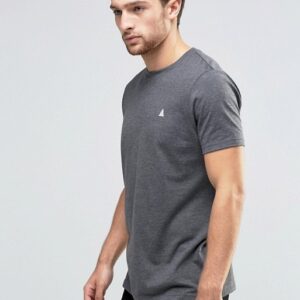 A man wearing a grey t - shirt and black pants.