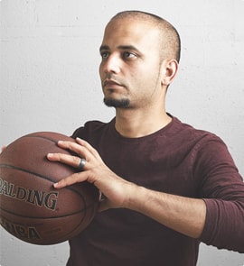 A man holding a basketball in his hand.