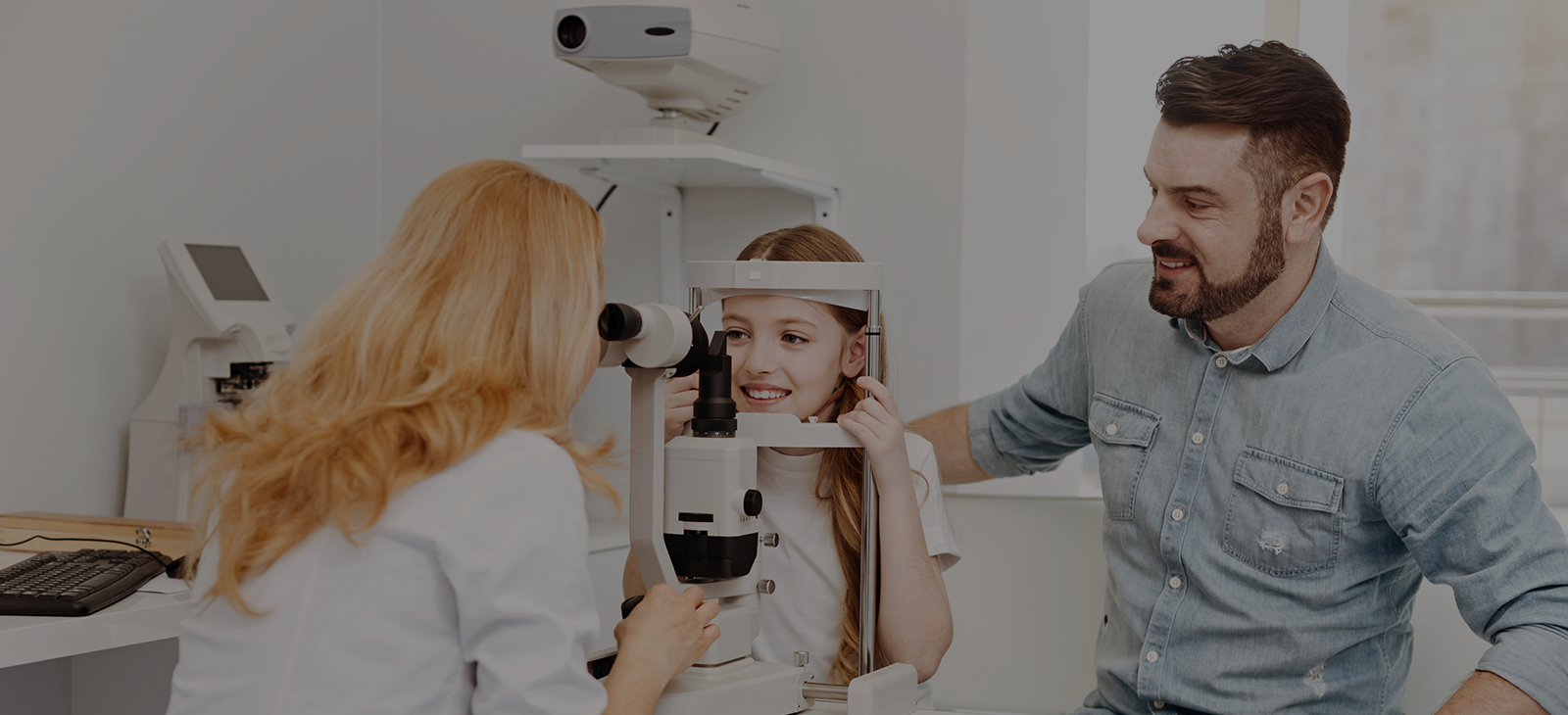A man and a woman are looking at an eye exam.
