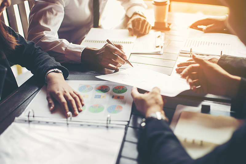 A group of business people working together at a table.